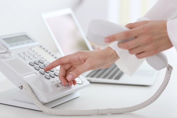 dialing on white phone voip service laptop 1-voip residential